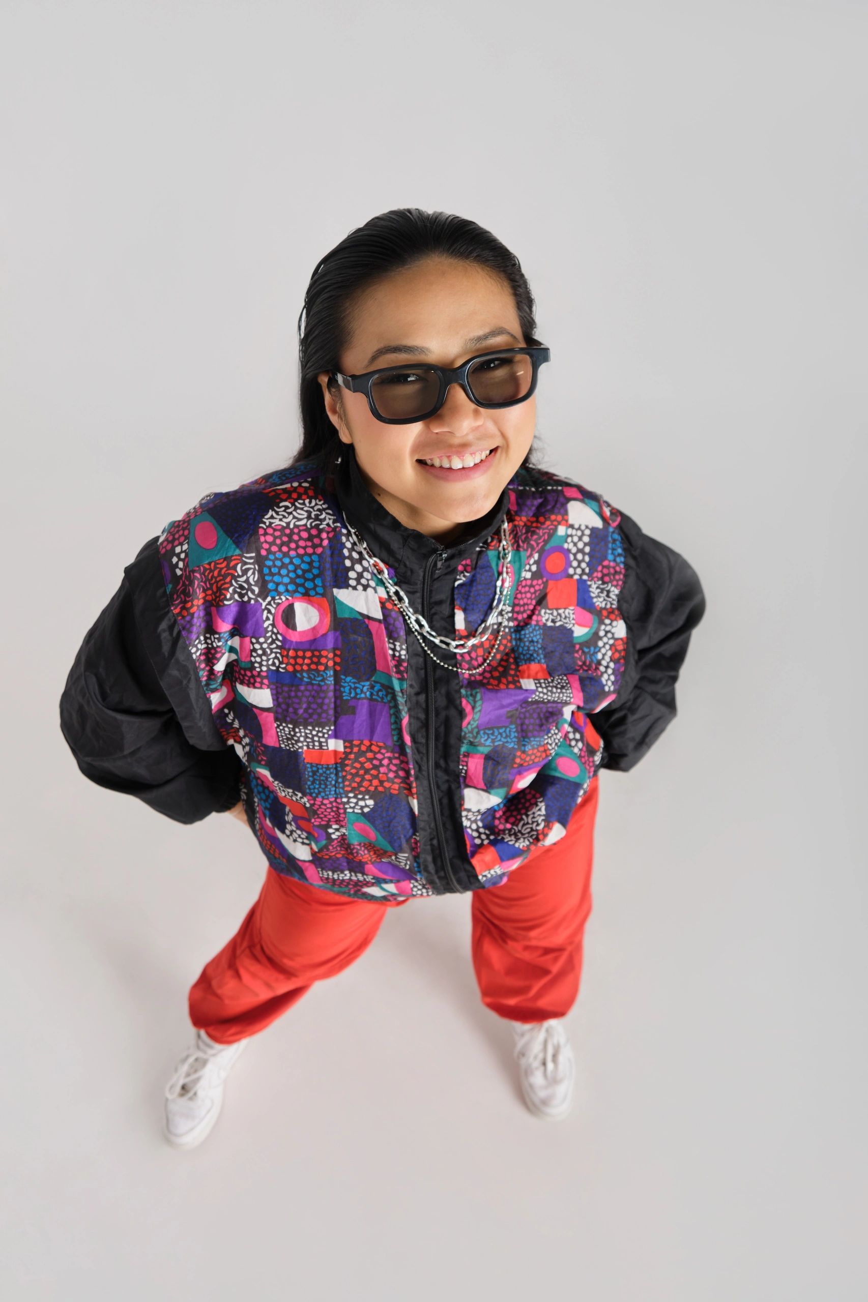 Stylish young woman in bold red clothing smiling at the camera