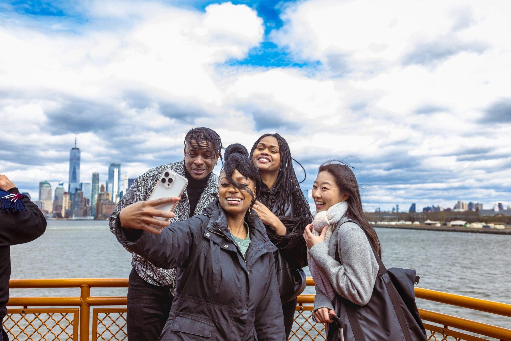Young friends taking a selfie on a waterfront ferry deck