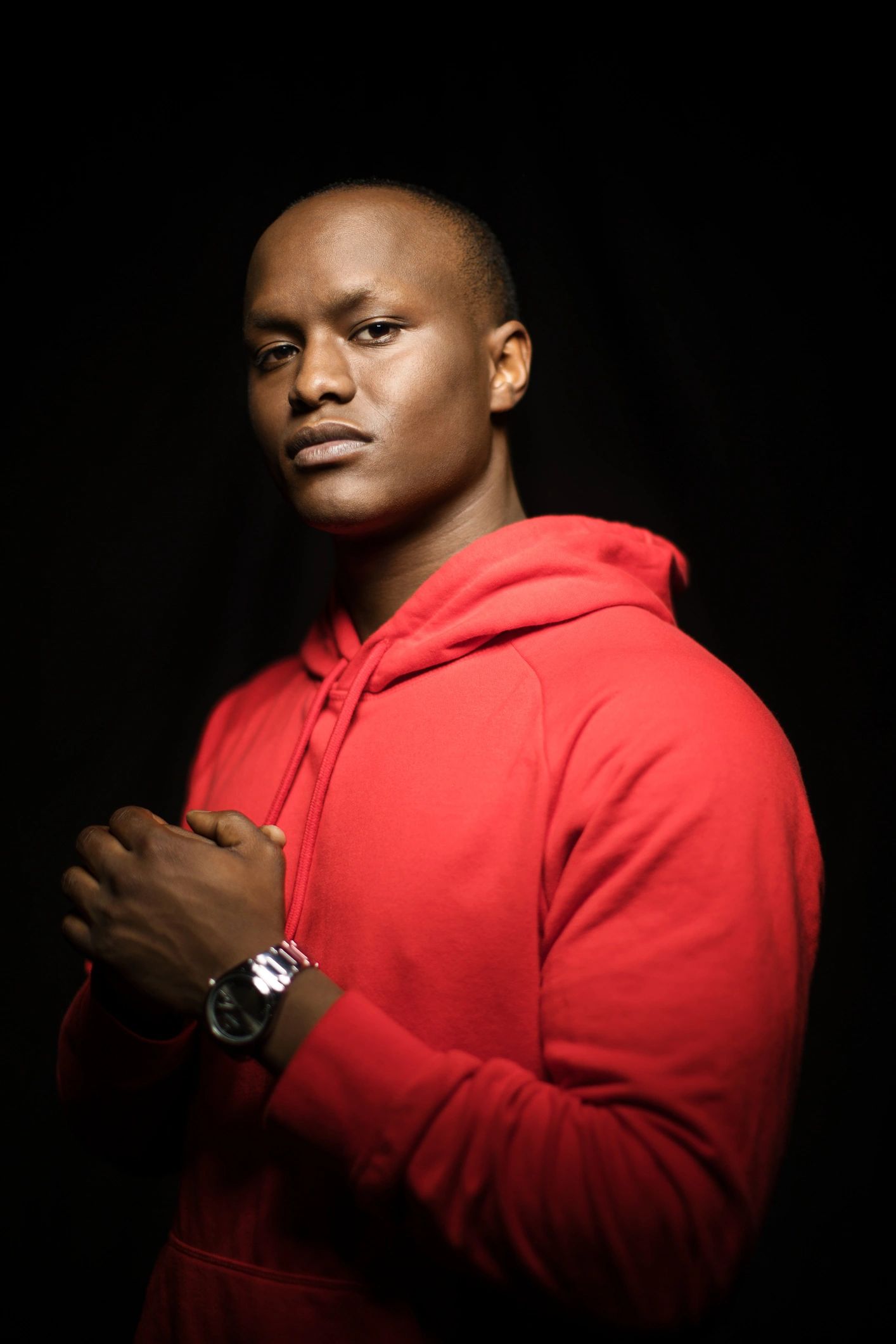 Portrait of a confident young man in a red hoodie